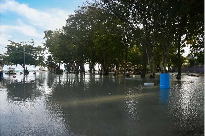 A flooded parking lot is seen after the passing of Hurricane Beryl in Worthing, Christ Church, Barbados