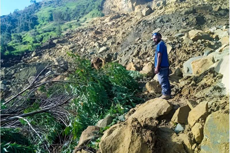 A man stands at the site of a landslide in Papua New Guinea's Enga Province on May 24, 2024