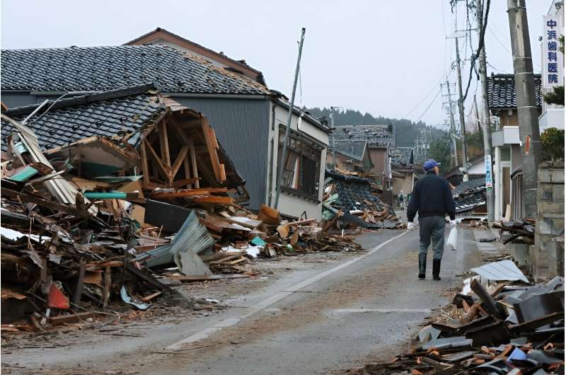 A man walks along a street of collapsed houses in Horyu Town,  Ishikawa Prefecture after a major 7.5 magnitude earthquake struck on February 1, 2024