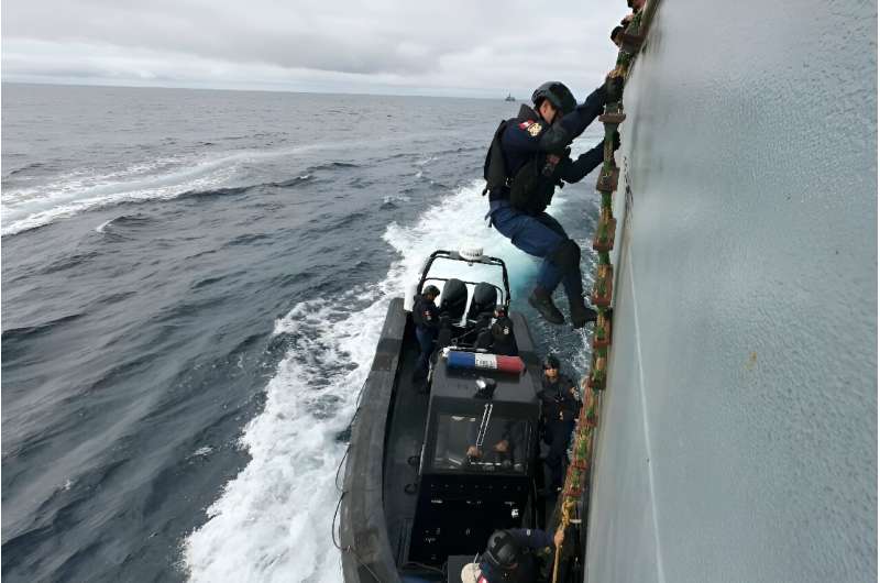 A Peruvian Navy sailor leaves the former poaching vessel Hualcopo during Galapex III, a maritime exercise to fight illegal fishing off the Galapagos Islands, on July 1, 2024