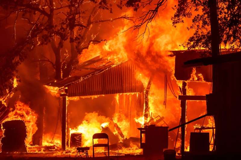 A property is seen in flames as the Park Fire burns near Paynes Creek, California on July 26, 2024