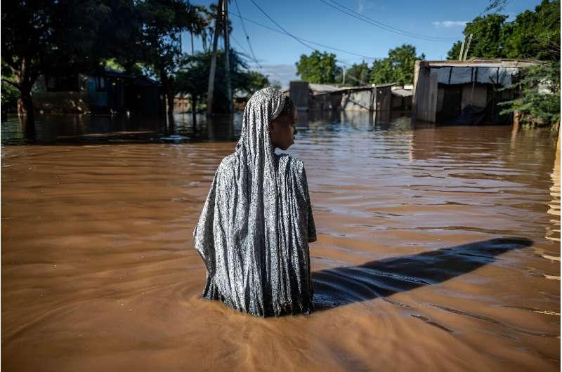 A woman wades through floodwaters in Garissa, Kenya earlier this month