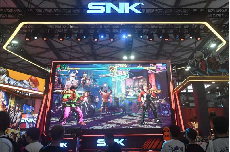 Attendees visit the booth of Japanese video game company SNK at the annual ChinaJoy digital entertainment expo