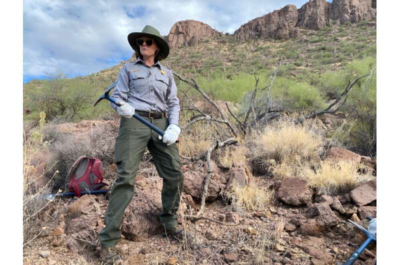 Biologist Frankie Foley shows volunteers how to remove buffelgrass in Saguaro National Park