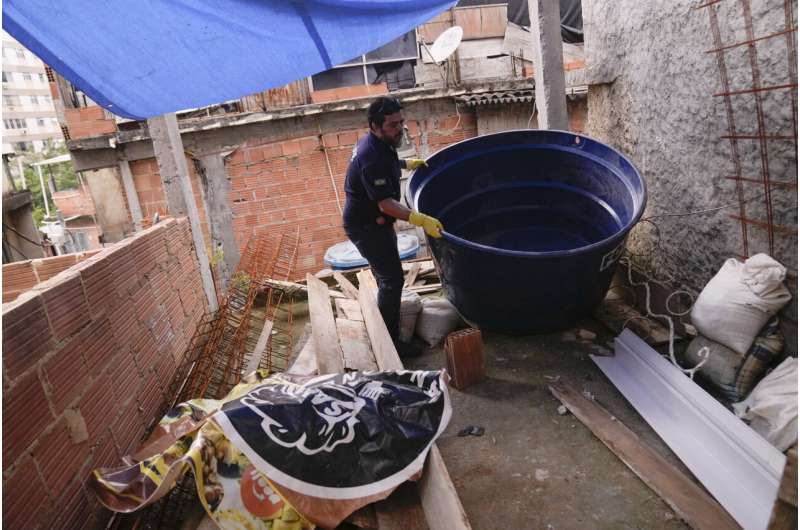 Brazil's health agents scour junkyards and roofs for mosquitos to fight dengue epidemic
