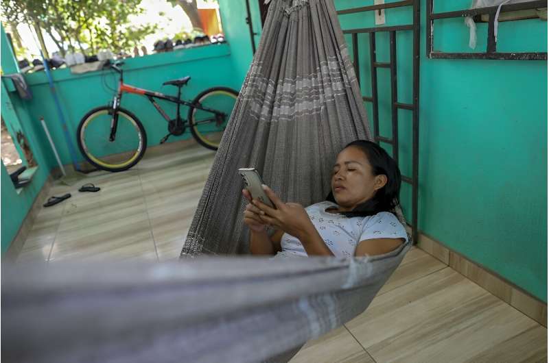 Cristina Quirino Mariano, a member of the Ticuna people, writes a message using the Linklado app in Manaus, northern Brazil
