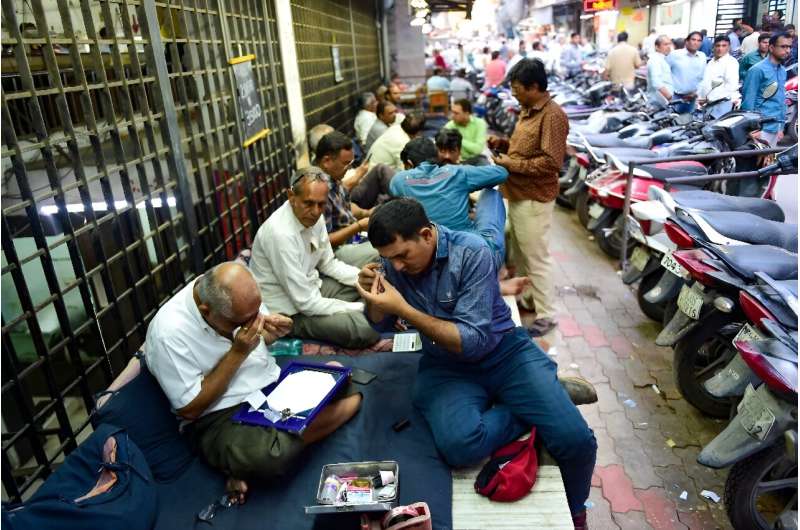 Diamond traders in the west Indian city of Surat, where 90 percent of the world's diamonds are cut and polished