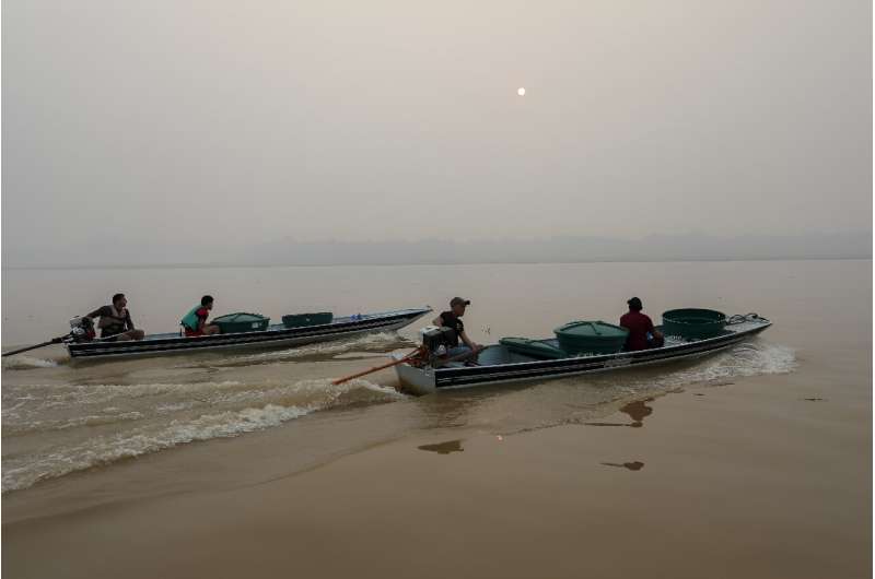 Drinking water is transported by boat on the Madeira River in Amazonas state