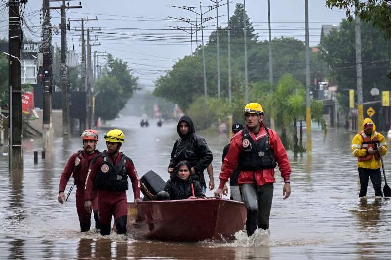 Firefighters rescue locals in a boat, at Santos Dumont neighbourhood in Sao Leopoldo, Rio Grande do Sul, Brazil, on May 12, 2024