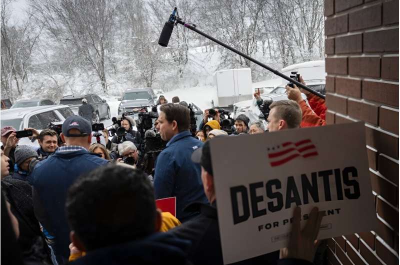 Florida Governor and 2024 Republican presidential hopeful Ron DeSantis speaks to the press outside of his campaign headquarters in Urbandale, Iowa, on January 12, 2024