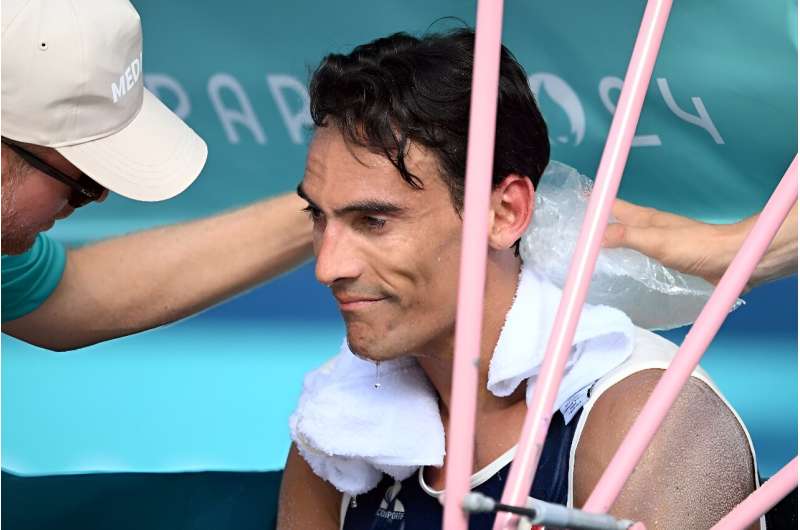 France's Youssef Krou cools off in the beach volleyball