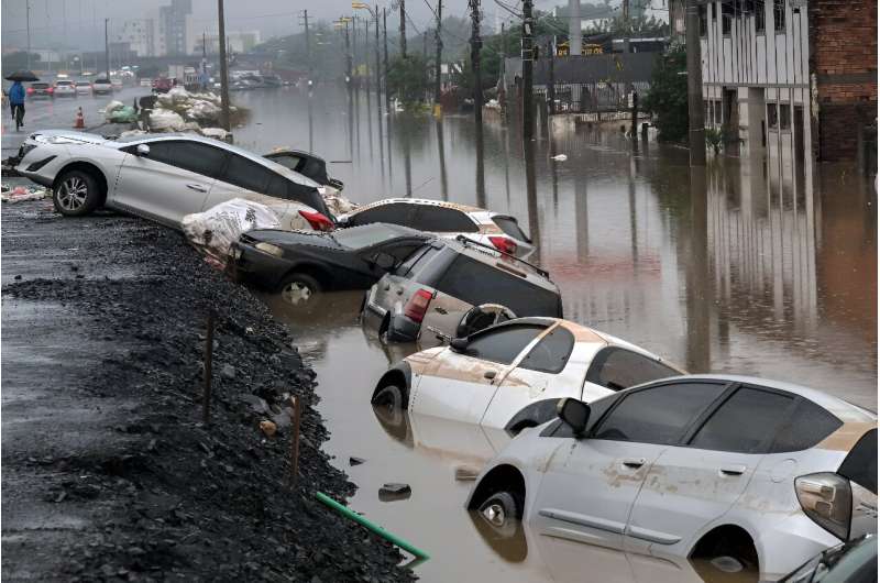 Further north in the town of Sao Leopoldo, cars lie half submerged where they had parked along the road, as people rowed boats down flooded streets.