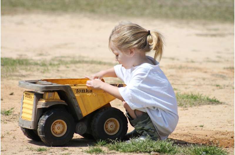 girl playing with truck