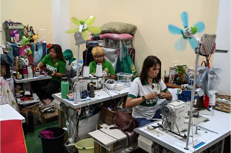 Government workers craft recovered plastic waste at a facility in Paranaque, Metro Manila