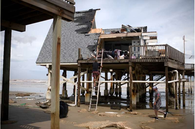 Mike Isbell inspects his destroyed waterfront home in Surfside Beach, Texas, after Hurricane Beryl made landfall