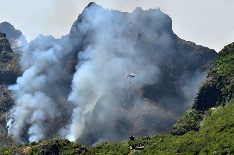 More than 100 firefighters are battling the blaze on two main fronts on the island