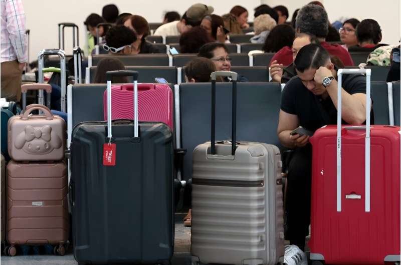 Passengers crowded into airports to wait for news as dozens of flights were cancelled