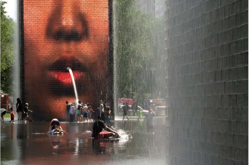 People cool off at Crown Fountain in Chicago's Millennium Park, as temperatures soar and officials warn of extreme heat