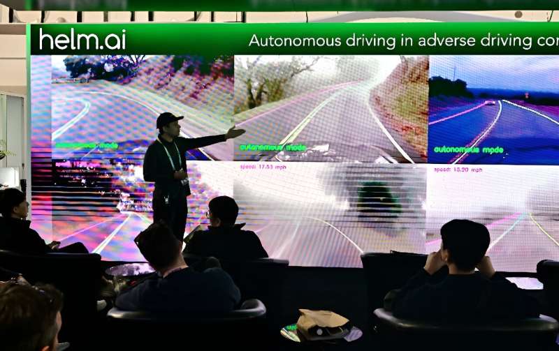 People sample an autonomous driving experience from Helm.ai during a display at the Consumer Electronics Show