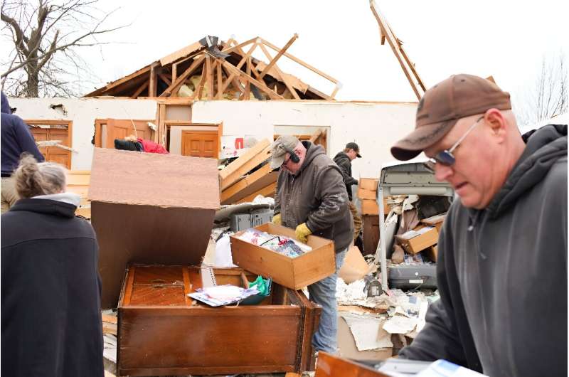 Residents sift through the debris as they clean up after a tornado struck Indian Lake, Ohio on March 15, 2024