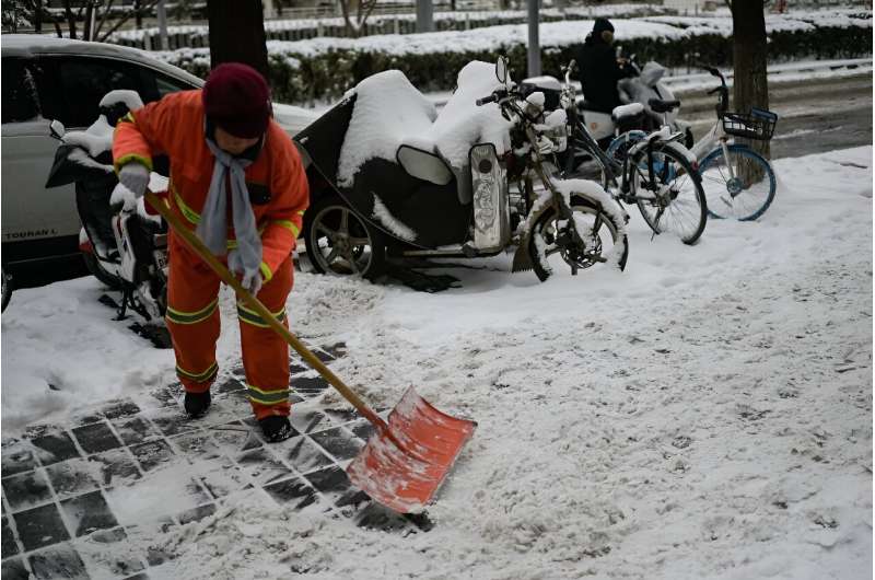 Severe weather warnings were in place across swathes of China on Wednesday as temperatures plummeted across the south and Beijing shivered in snowy conditions
