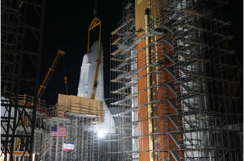 Space Shuttle Endeavour hoisted for installation in vertical display at Los Angeles science museum