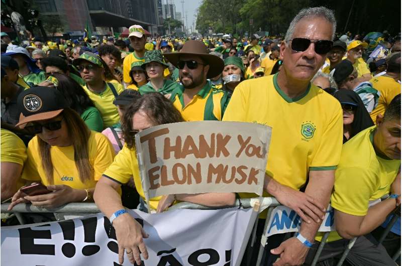 Supporters of former Brazilian President Jair Bolsonaro (2019-2022) hold a sign thanking X social media platform owner Elon Musk, during an Independence day rally in Sao Paulo, Brazil on September 7, 2024