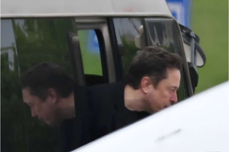 Tesla CEO Elon Musk gets off a minibus before boarding his private plane at Beijing airport