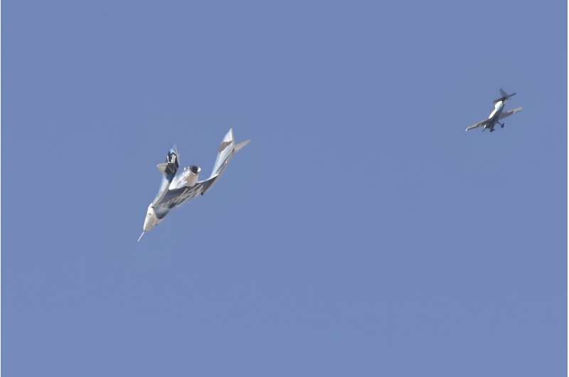 The Virgin Galactic SpaceShipTwo spaceplane Unity and mothership separate as they fly way above Spaceport America in New Mexico in July 2021 on the way to the cosmos