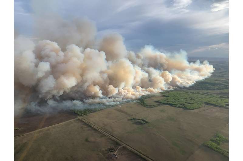 This aerial handout picture courtesy of the Alberta Wildfire Service, taken May 10, 2024, shows smoke from wildfires burning in the Grande prairie forest area, 4 kilometers east of the town of Teepee Creek, in Alberta, Canada