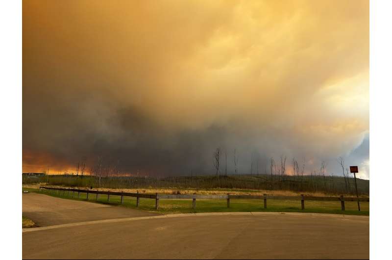 This handout image courtesy of Kosar shows smoke and flames from the fire near Fort McMurray, Canada on May 14