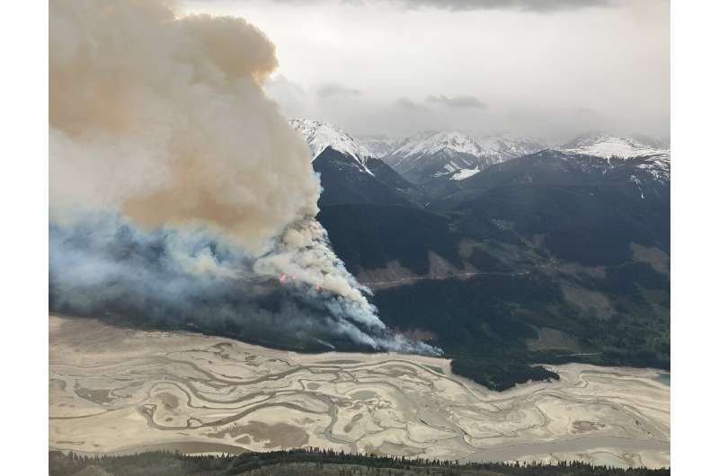 This handout image released by BC Wildfire Service shows smoke columns from the Truax Creek wildfire on May 12
