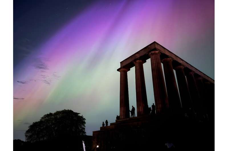 This handout photo taken and released by Jacob Anderson shows the northern lights, or aurora borealis, during a solar storm over the National Monument of Scotland in Edinburgh