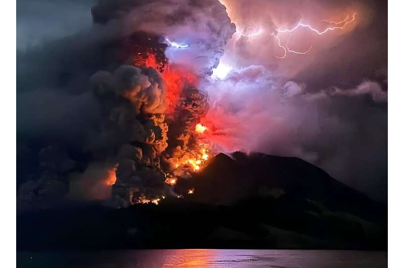 This handout photograph taken and released by the Center for Volcanology and Geological Hazard Mitigation on April 17, 2024, shows Mount Ruang spewing hot lava and smoke