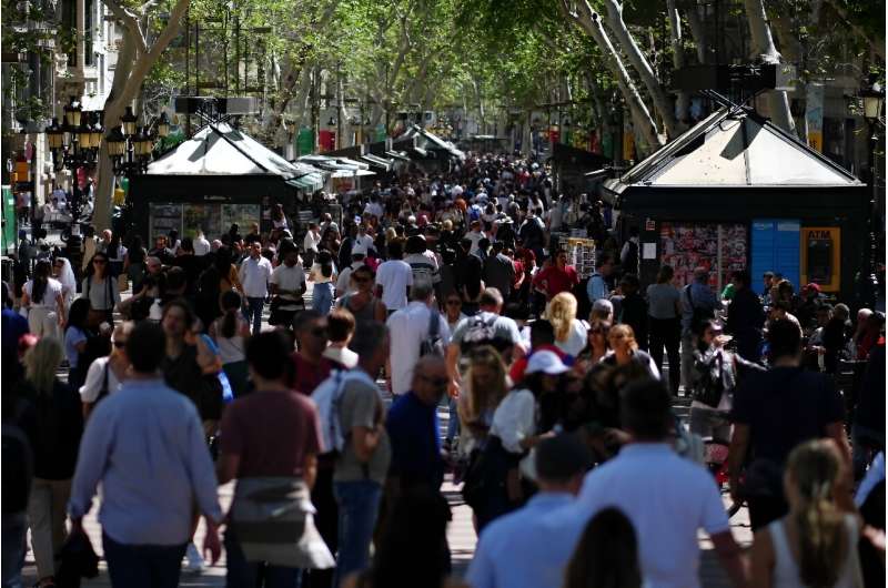 Tourists crowd Las Ramblas alley in Barcelona