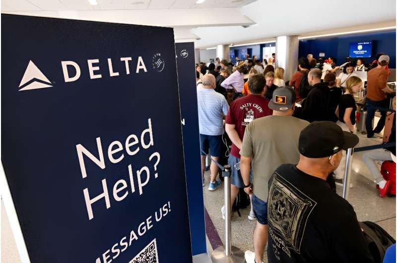 Travelers wait in line at the airport in Los Angeles, California on July 19, 2024 following a global IT crash that hobbled airlines, banks, broadcasters and other businesses