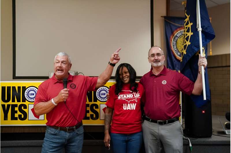 United Auto Workers (UAW) President Shawn Fain, right, celebrates with local organizers at a UAW vote watch party on April 19, 2024 in Chattanooga, Tennessee
