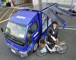 Japanese electronics giant Sanyo Electric displays a truck with solar panels for charging electric powered bicycles