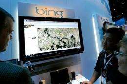 Microsoft's Roger Wong (2nd R) demonstrates maps using Bing
