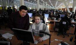 A blind trainee at a hi-tech call centre gets instructions from a supervisor