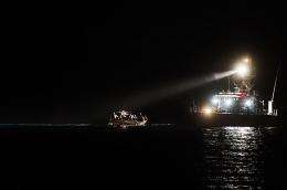 A boat full of illegal immigrants enters the port of the Italian island of Lampedusa escorted by a Coast Guard vessel