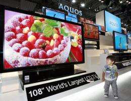 A boy looks at a prototype model of the world's largest 108-inch sized LCD TV