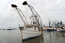 A fiishing boat approaches a dock to make repairs in Pass Christian, Mississippi