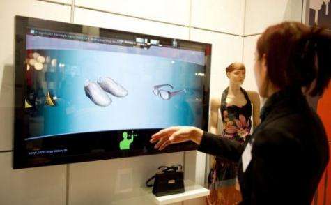 A girl demonstrates the "Interactive shopping window"