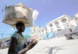 A Haitian vendor sells goods on October 14, near the destroyed Port-au-Prince Cathedral