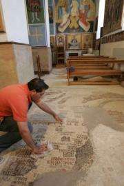 A Jordanian man cleans the Madaba Map