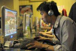 A man plays online games at an internet cafe in Beijing