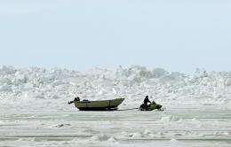 A man pulls a whaler's boat across the frozen Arctic Ocean in Browerville, Alaska, in 2006