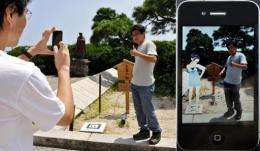 A man stands (L) has his photo taken with the doe-eyed cartoon character, Rinko