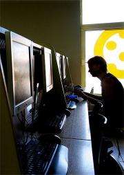A man surfs the web at an internet cafe
